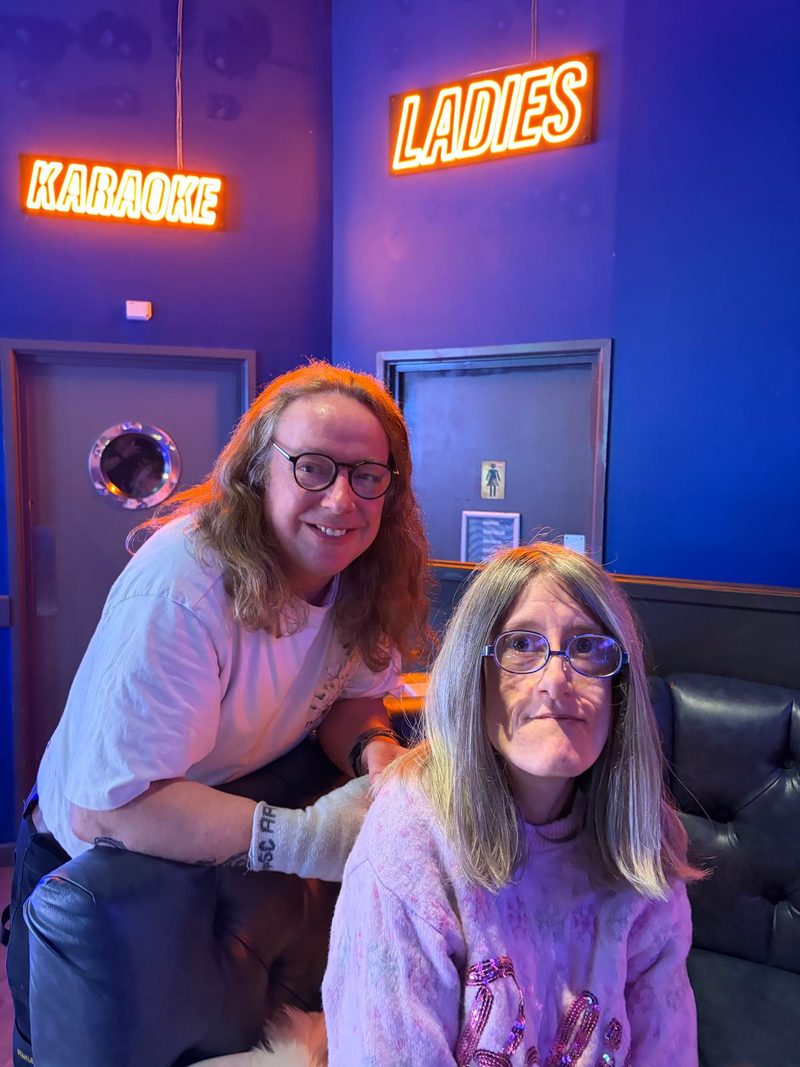 Two members enjoying a karaoke social evening